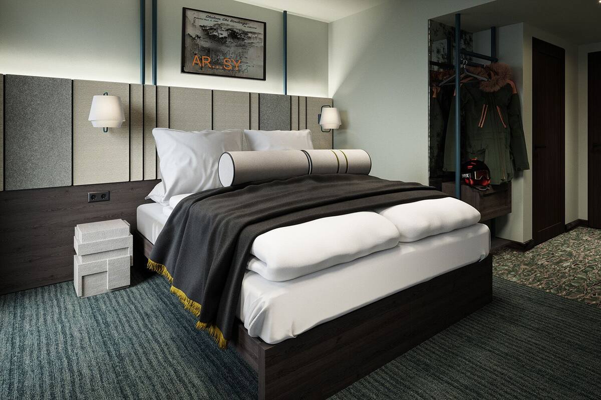 A modern hotel room with a large bed, two bedside tables, a headboard with built-in lighting, a coat rack, and a framed picture on the wall.