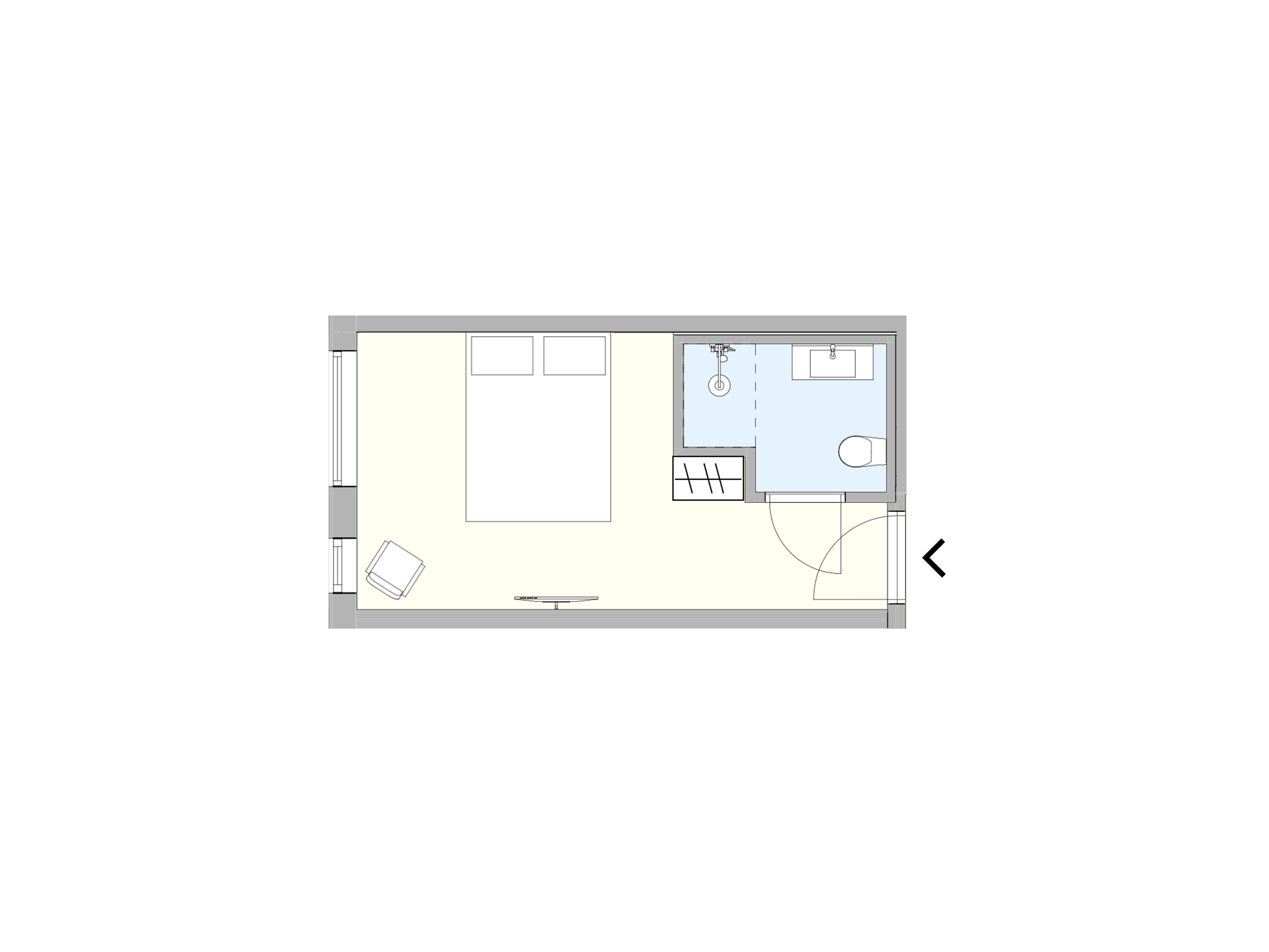 A floor plan of a hotel room with a bed, a desk, a chair, a bathroom, and a small sitting area.