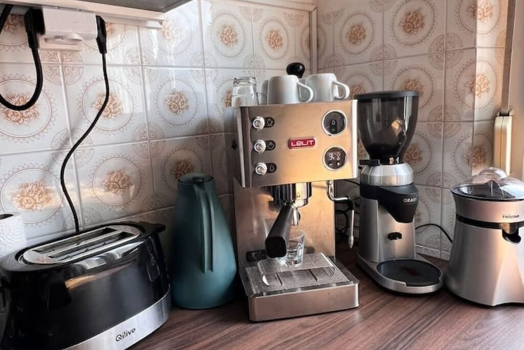 A kitchen with a coffee machine, a toaster, and a kettle.