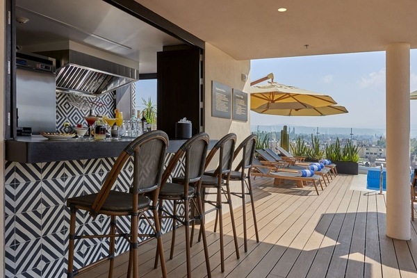 Lounge in the sun with bar service and rooftop vistas.