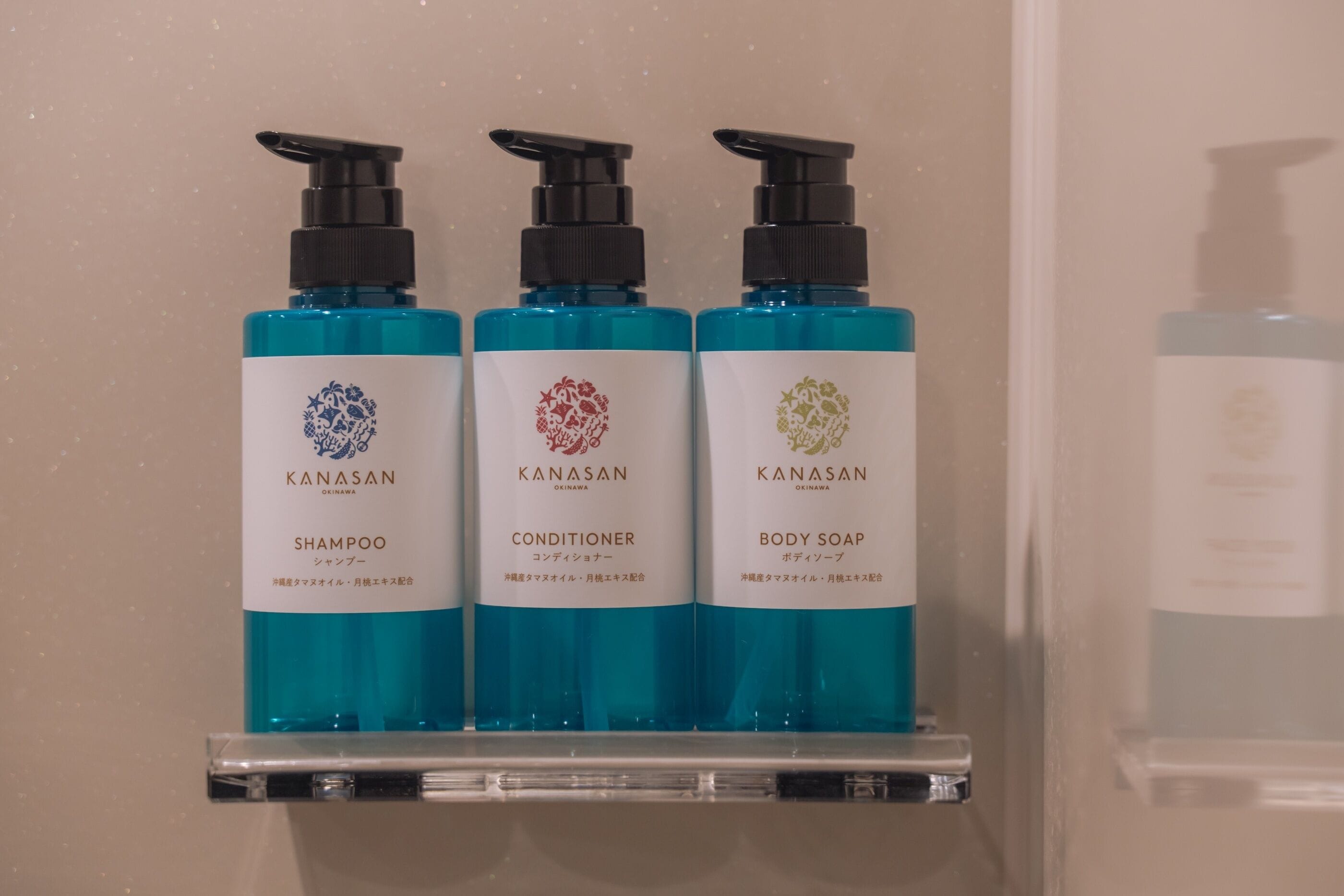 Three bottles of Kanasan products on a shelf.