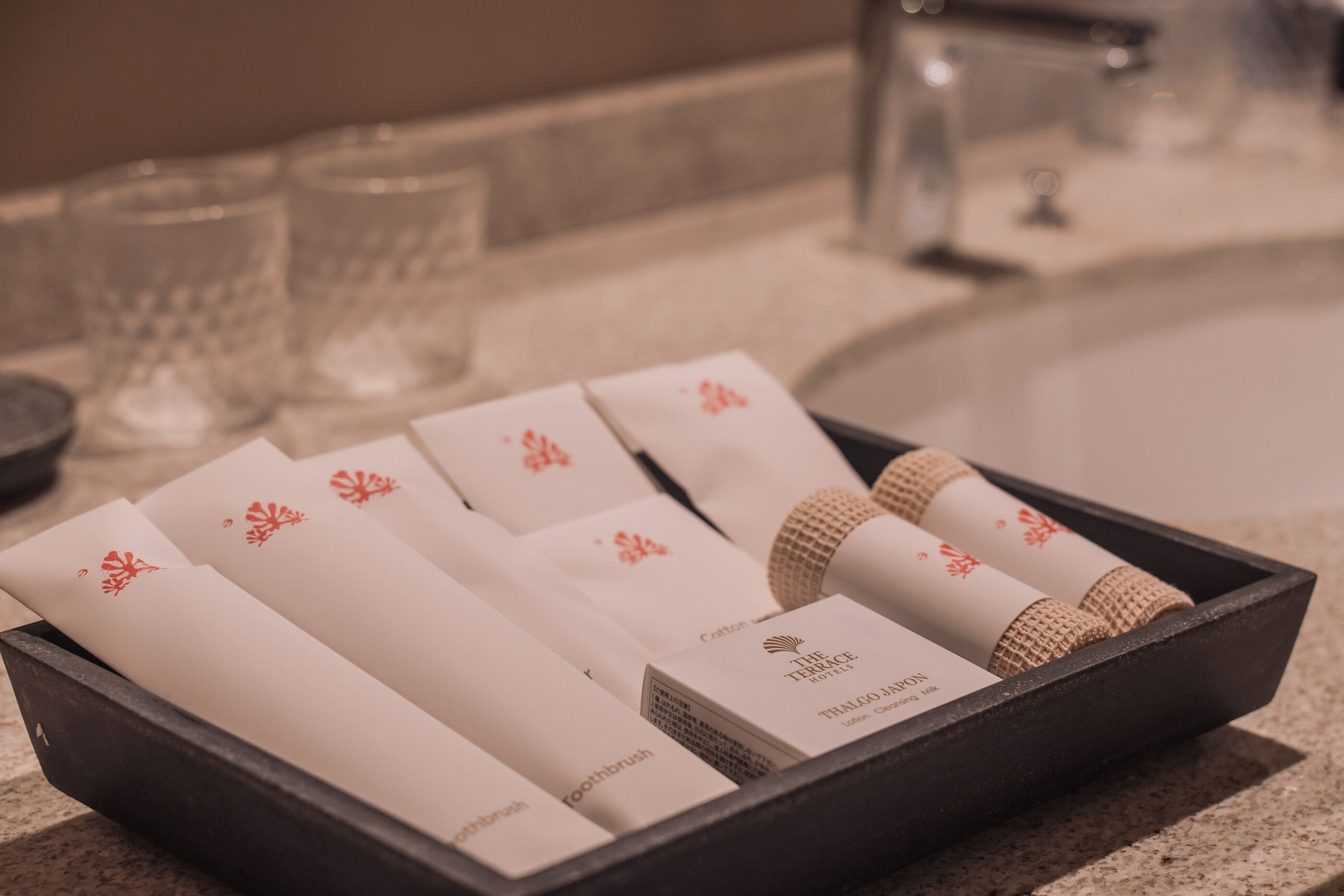 A tray with toiletries including a toothbrush, toothpaste, and a bar of soap.