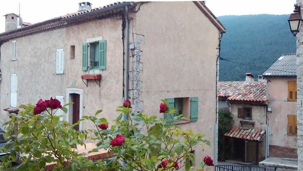 A traditional building with a rustic facade, green shutters, and a visible chimney. - La Maison Commune - CAILLE (CAILLE)