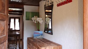 A wooden bench with a book titled "Lyon" and a mirror on the wall.