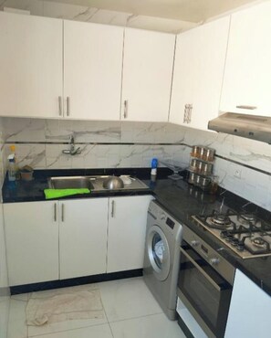 Fridge, stovetop, dishwasher, coffee/tea maker