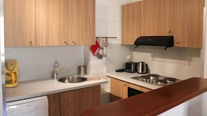 A modern kitchen with wooden cabinets, stainless steel appliances, and a Bosch dishwasher.
