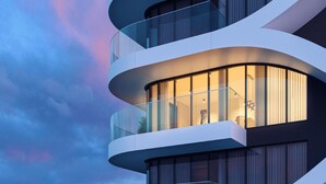 A modern building with curved balconies and large windows. - Oceanview Pearl Apartment (Funchal)