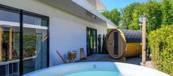 Luxury 16-person villa by the water. Two spacious villas with hot tubs, Finnish saunas, private jetties, large terraces, and modern kitchens.