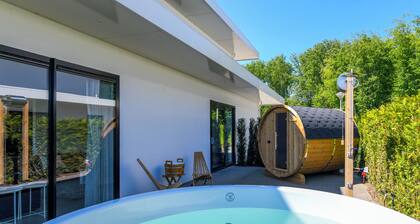 Luxury 16-person villa by the water. Two spacious villas with hot tubs, Finnish saunas, private jetties, large terraces, and modern kitchens.