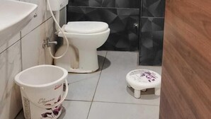 A bathroom with a toilet, sink, and bidet. - Agralok Dham (Ujjain)