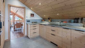 A modern kitchen with wooden cabinets, granite countertops, and a built-in sink.
