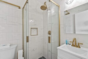 Shower, hair dryer, towels, shampoo