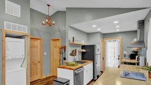 A modern kitchen with wooden cabinets, a central island, and built-in appliances. - King Size - Romantic - Massage - Pet Friendly (Blakeslee)