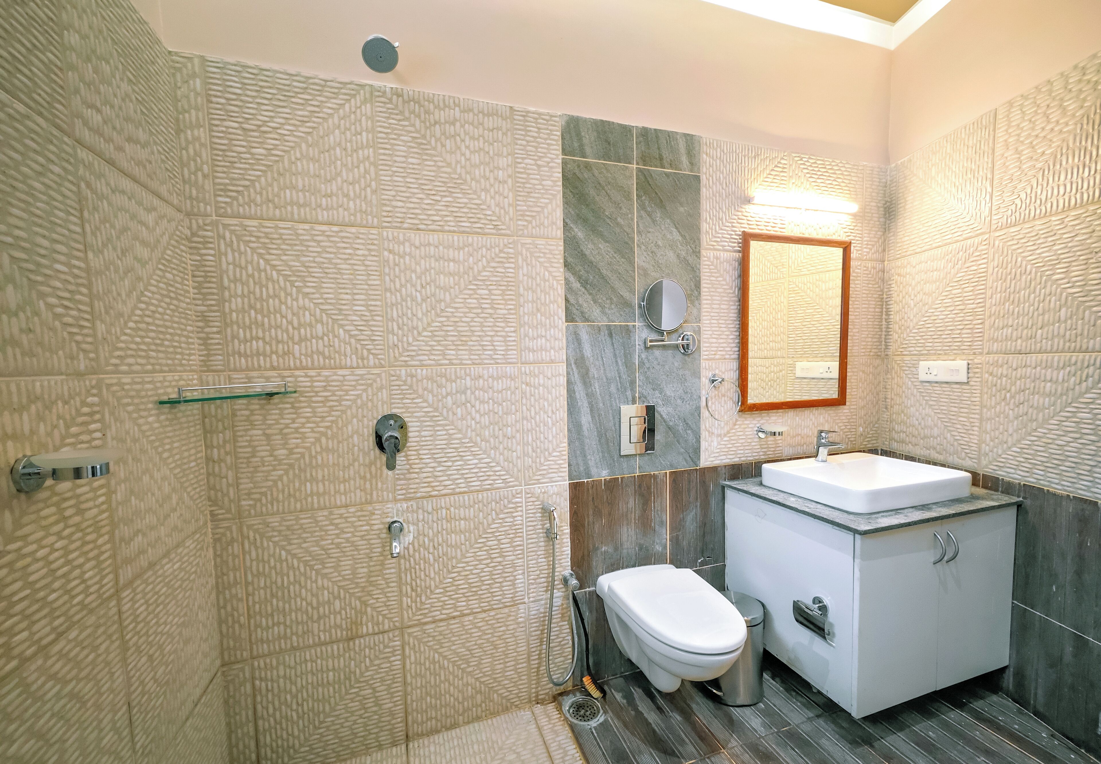 A modern bathroom with a shower, toilet, and sink.