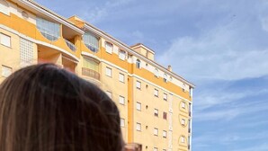 A person overlooking a swimming pool with a building in the background. - Family Beach Stay • 2 Bedroom • Fast Wi‑Fi • Sunny Terrace (Villajoyosa)
