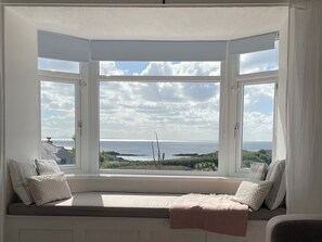 A bay window with a view of the sea and distant land. - No.7 Plas Darien (Holyhead)