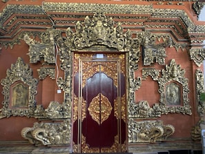 A richly decorated door with intricate carvings and a central emblem.