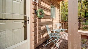 A wooden cabin with a porch, a door, and a sign reading "258B Vista Dr."