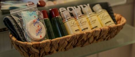 A wicker basket containing toiletries on a glass shelf.
