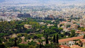 A cityscape with a mix of modern and historical architecture, including a prominent classical building and dense urban development. - Athens Residence Cozy Suite Near Acropolis (Athens)