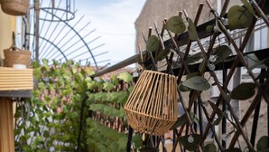 Ein Garten mit einem Korankorb, der an einem Spalier hängt, umgeben von grünem Laub.