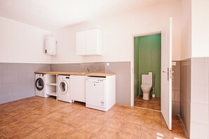 A laundry room with a washing machine, dryer, and dishwasher.