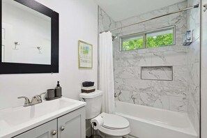 Shower, hair dryer, towels, shampoo