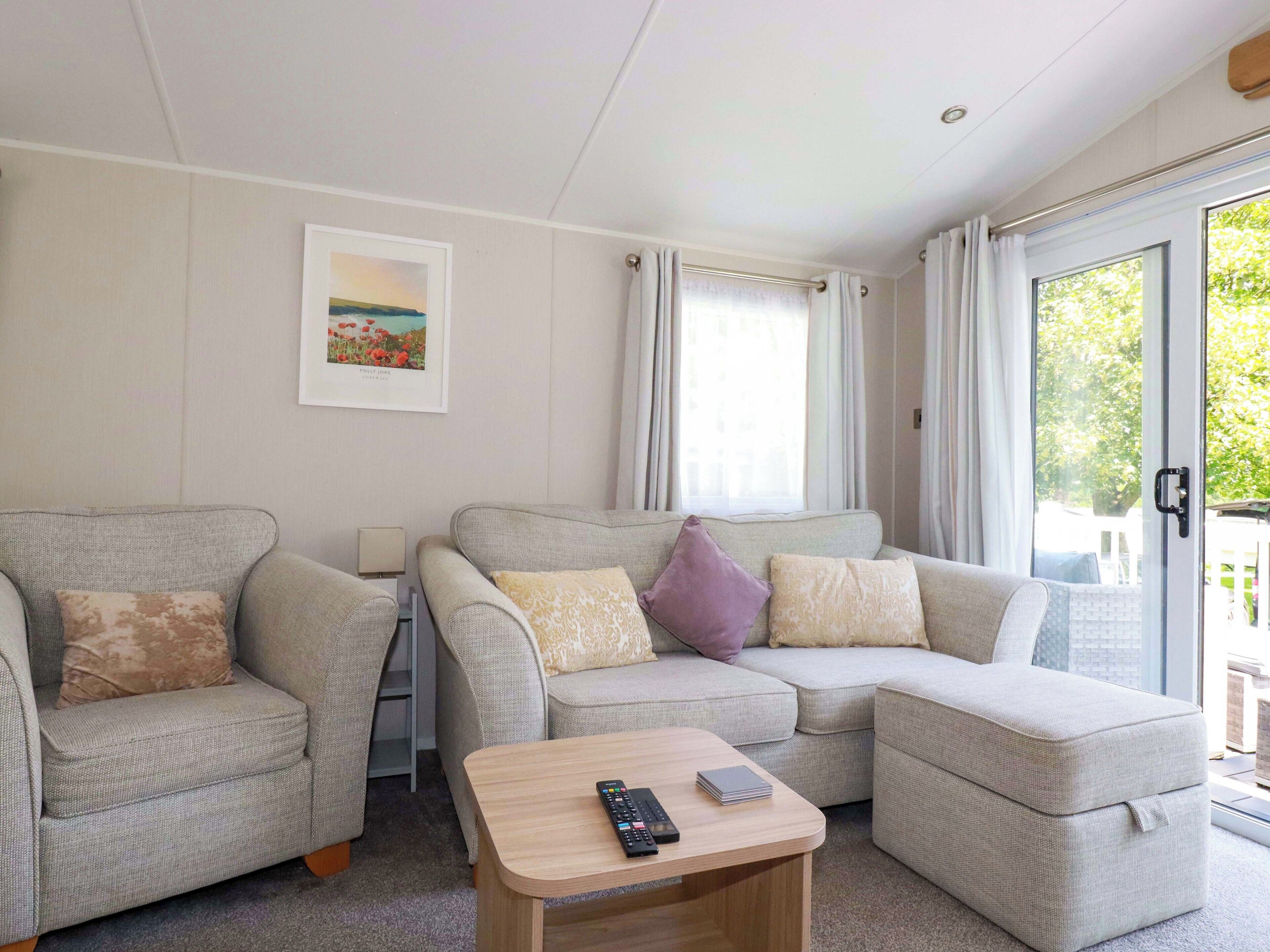 A living room with two sofas, a coffee table, and a TV.