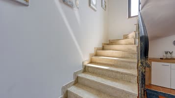A staircase with beige steps leading to a landing.