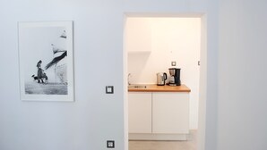 A modern kitchen with white cabinets, a wooden countertop, and a coffee maker. - Athens Residence A1 - Cozy Nest near Acropolis (Athina)