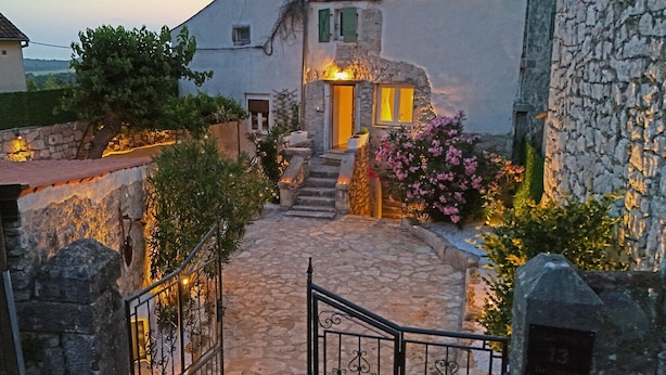 A stone pathway leading to a house with a stone wall and a gate. - Holiday house Vento (Poreč)