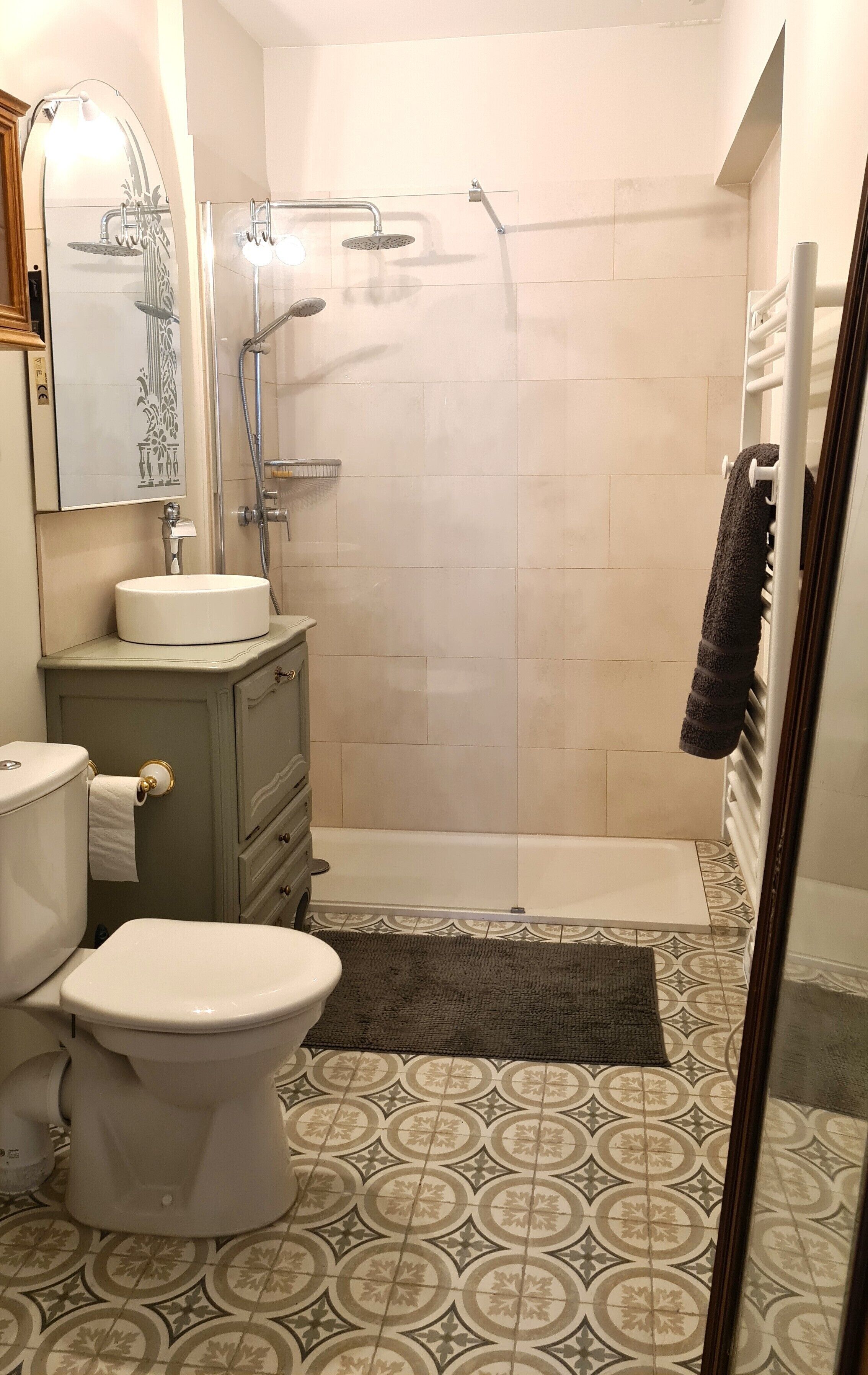 A bathroom with a toilet, sink, and shower.