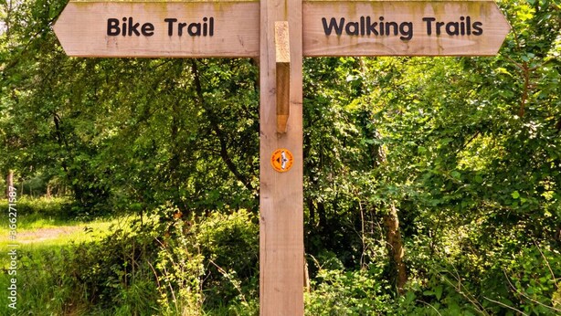 A wooden signpost with directions for a bike trail and walking trails. - Shepherd's Lodge at Morrells Wood (Shrewsbury)
