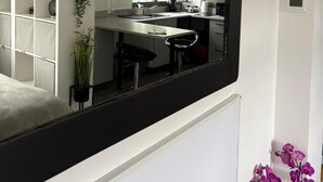 A modern kitchen with white cabinetry, a black countertop, and a large window. - Peaceful escape in historic Meath near Slane, Tara, Newgrange, and Dublin (Slane)