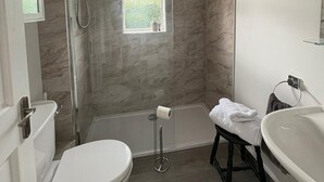 A modern bathroom with a toilet, shower, and sink. - Peaceful escape in historic Meath near Slane, Tara, Newgrange, and Dublin (Slane)