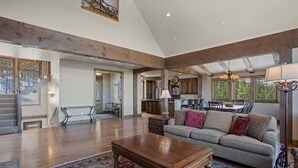 A spacious living area with a wooden coffee table, a sofa with cushions, and a large rug. - Top Of the World (Crested Butte)