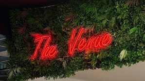 A neon sign with 'The Venue' in red, surrounded by green foliage. - River Meadows Retreat. Contemporary, spacious caravan. 3 Bedroom, sleeps 8 (Great Billing)