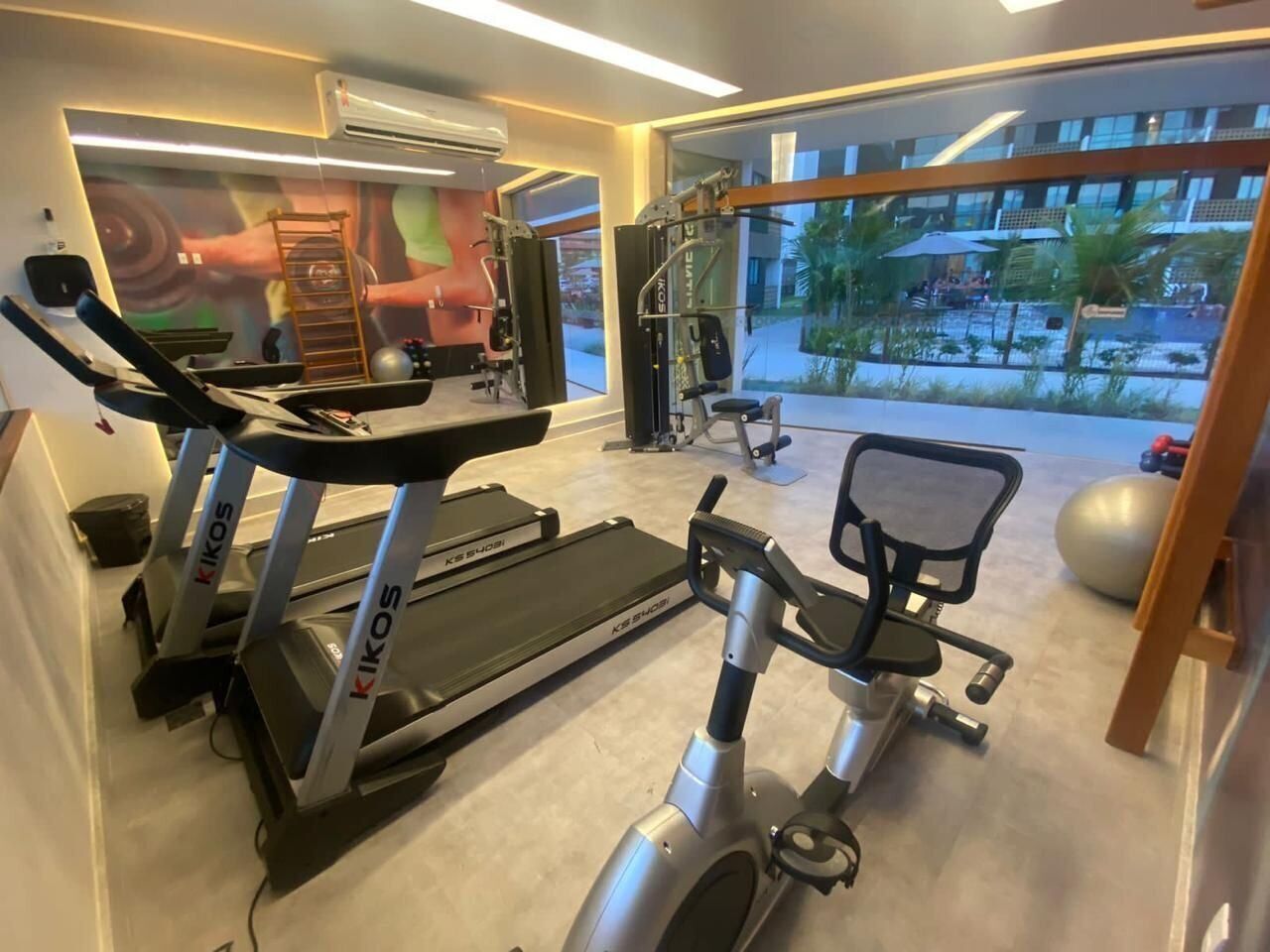 A gym with treadmills, a stationary bike, and a weight machine.