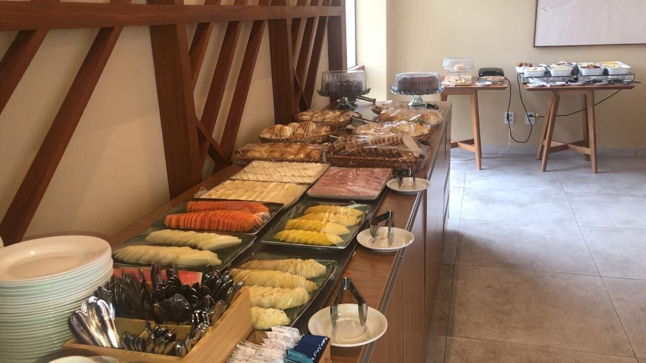 A buffet with various food items and utensils.