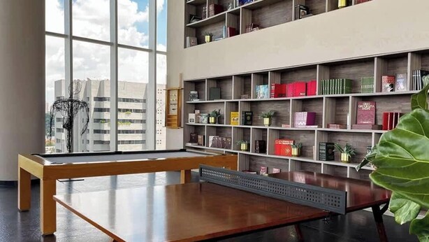 A modern library with a pool table, bookshelves, and a large window. - Panoramic City View I Near Colomos (Guadalajara)