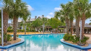 A swimming pool with palm trees and lounge chairs, surrounded by buildings. - Fall Break, Family Friendly, Walk2Beach & Pools, Golf Cart, 4BR, 2 Kings (Port St. Joe)