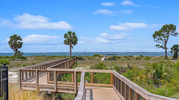 A wooden boardwalk leading to a beach with palm trees and a clear view of the ocean. - Fall Break, Family Friendly, Walk2Beach & Pools, Golf Cart, 4BR, 2 Kings (Port St. Joe)