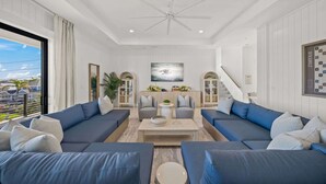 A modern living room with a large sofa set, a coffee table, and a painting on the wall. - New-Endless Amenities-Unmatched Rooftop & Views (Clearwater)
