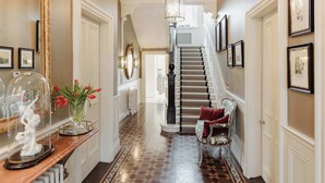 A grand hallway with a marble floor, a staircase, and a chandelier. - Private and Prestigious Luxury Home (Edinburgh)
