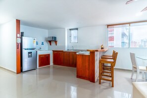 Fridge, microwave, coffee/tea maker, cookware/dishes/utensils