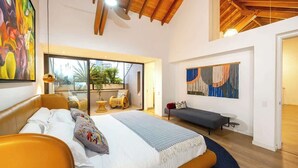 A modern bedroom with a large bed, a sofa, and a view of the outdoors. - |EP| Premium PH W/Sauna, Jacuzzi, SteamRoom (Medellín)