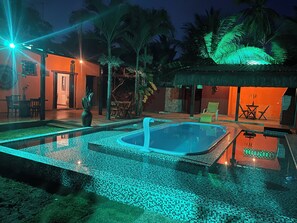 A pool area with a tiled deck, lounge chairs, and a small pool. - House Ponta da Crôa in Pontal de Maracaipe/PE (Maracaipe Ipojuca)