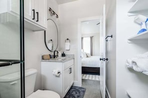 A compact bathroom with a toilet, sink, and shower area. - Pet Friendly w/Hot-Tub-Six Minutes to Downtown! (Fredericksburg)