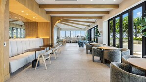 A modern interior with a long corridor, seating areas, and large windows. - Miami 72 Building - 360-degree Views - We host (Miami Beach)