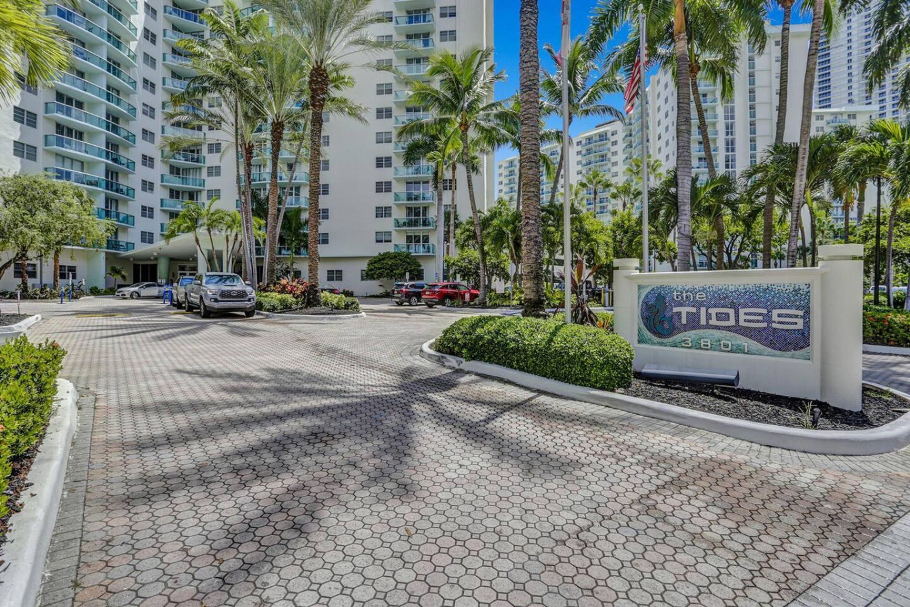 A hotel entrance with a sign reading "The Tides 3801".